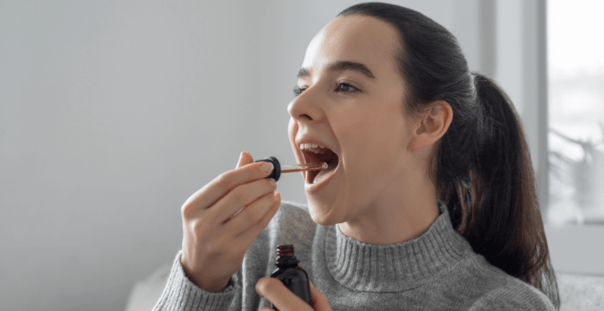 woman-dropping-cbd-oil-into-mouth