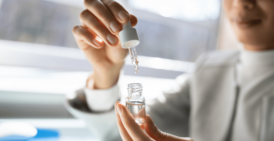 person-holding-bottle-of-cbd-oil-and-pipette