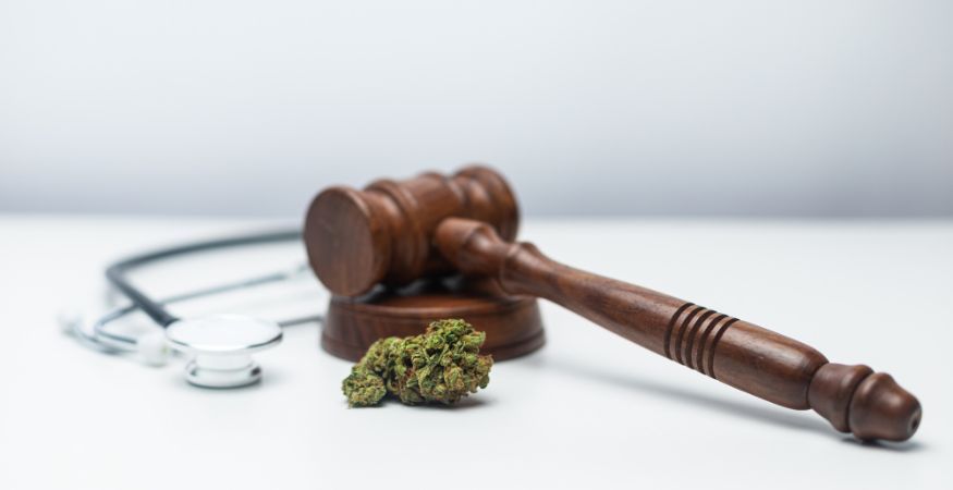 cannabis-flower-and-stethoscope-and-gavel-on-table.jpg