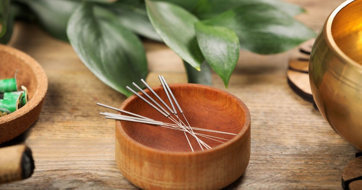 acupuncture needles in a wooden bowl