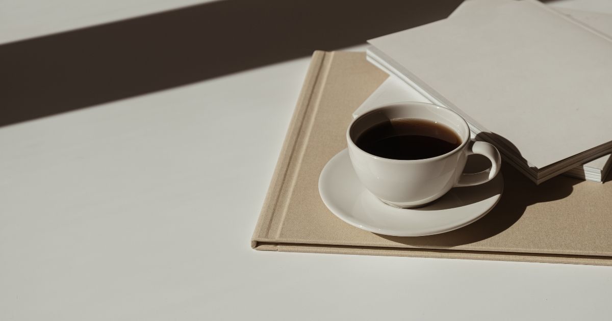 coffee mug and folders on a table