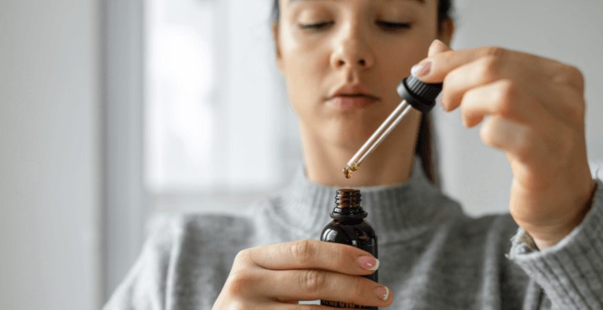 woman-holding-cbd-oil-and-pipette