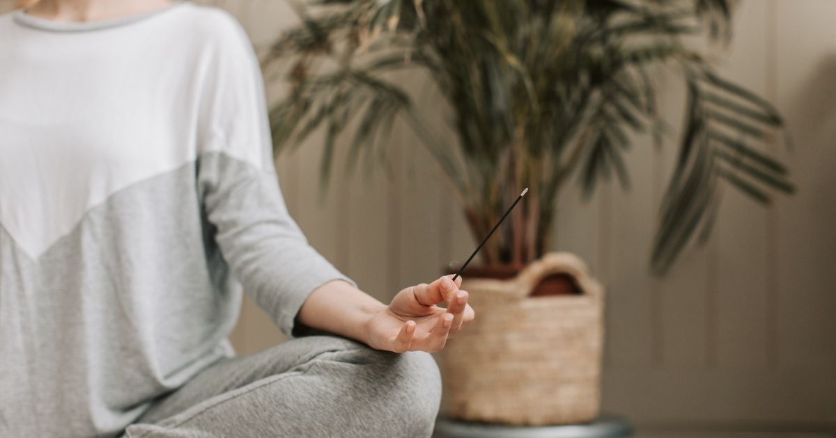 woman in a grey sweater meditating