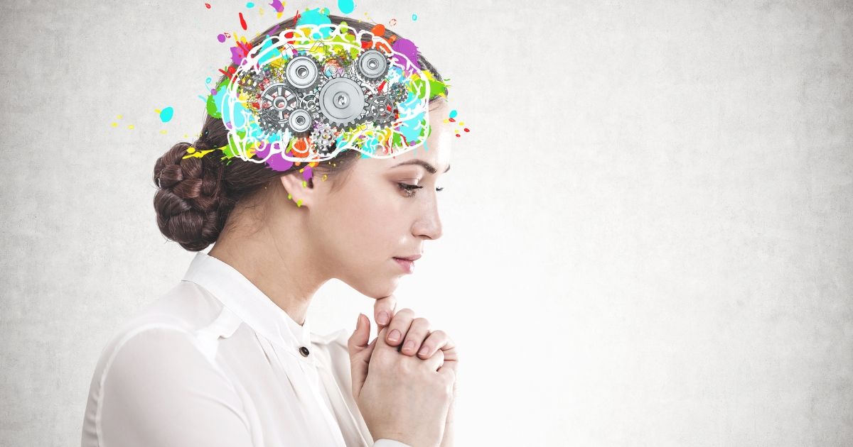 woman in a white shirt with a colourful illustration of a brain