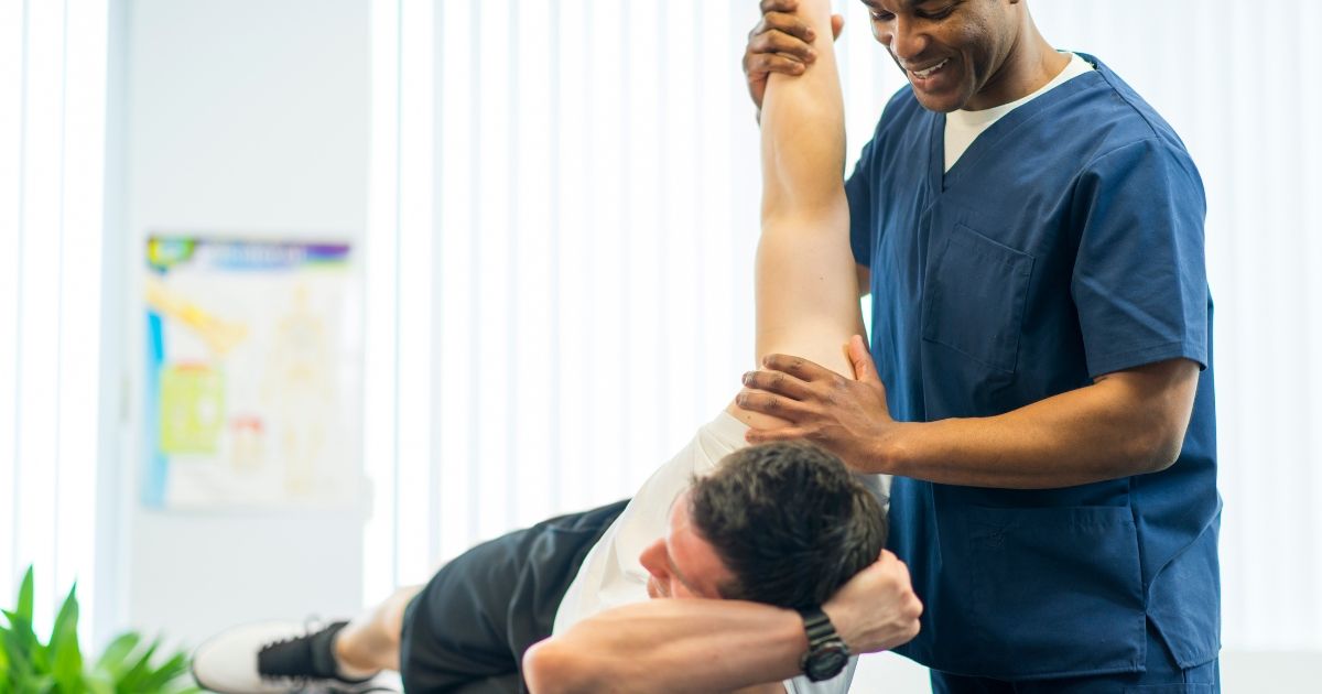 physical therapist helping patient with excersise