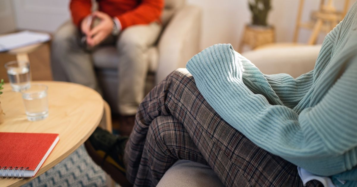 woman in a wollen sweater in a therapy session