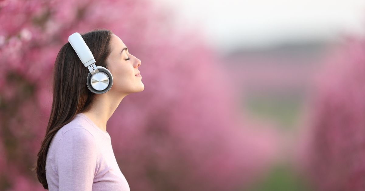 someone-using-headphones-and practicing-guided-meditation.jpg
