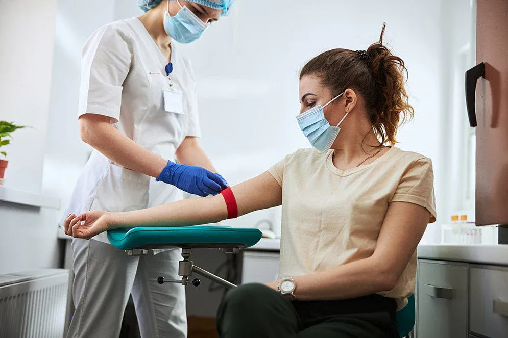 nurse-taking-doing-a-blood-test-on-a-woman